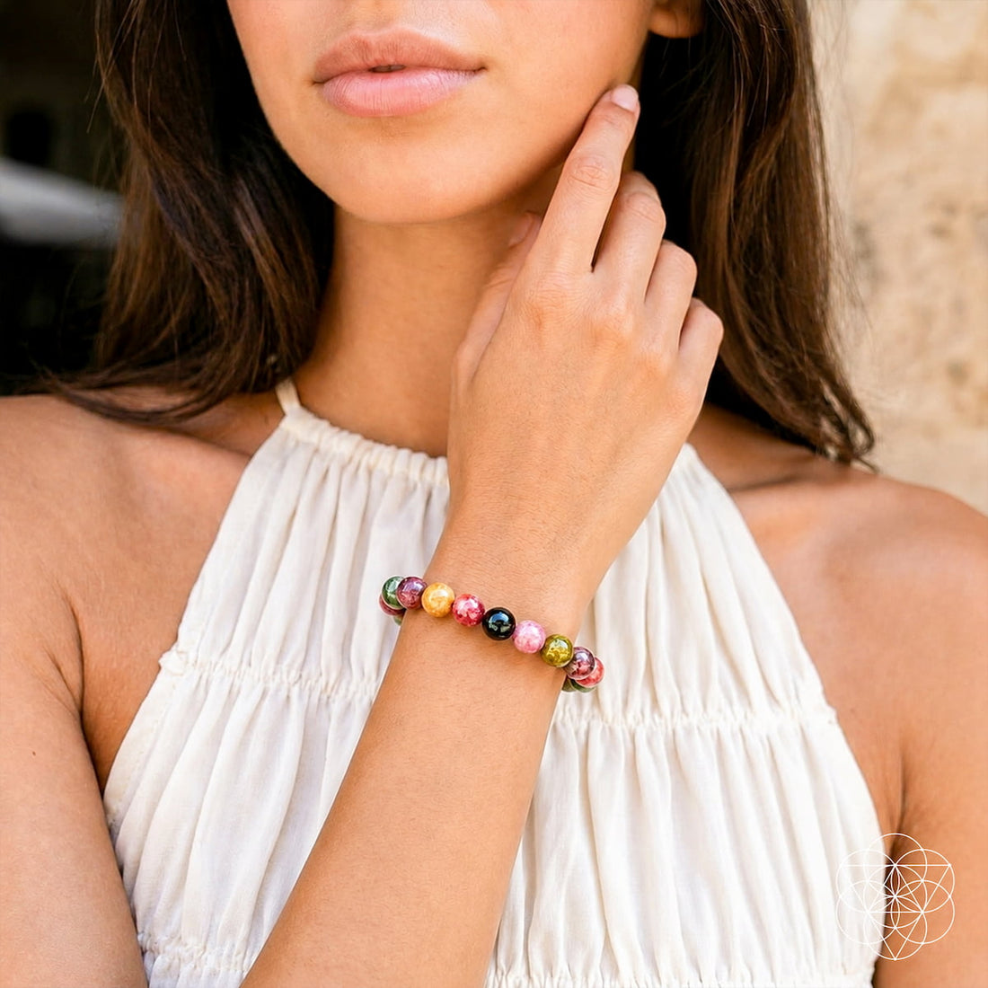Rainbow tourmaline bracelet with spiral design by Conscious Items, featuring vibrant multicolored gemstones on a silver-toned band.