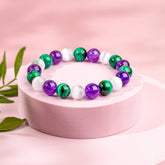 Close-up of The Triple Healing Bracelet by Conscious Items, featuring three healing gemstone beads on a delicate cord.