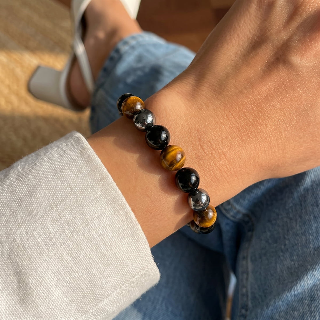 Bracelet with triple protection design from Conscious Items featuring layered black and silver beads.