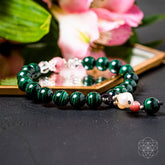 Conscious Items Law of Attraction bracelet featuring engraved charms on a black cord for positive energy and manifestation.