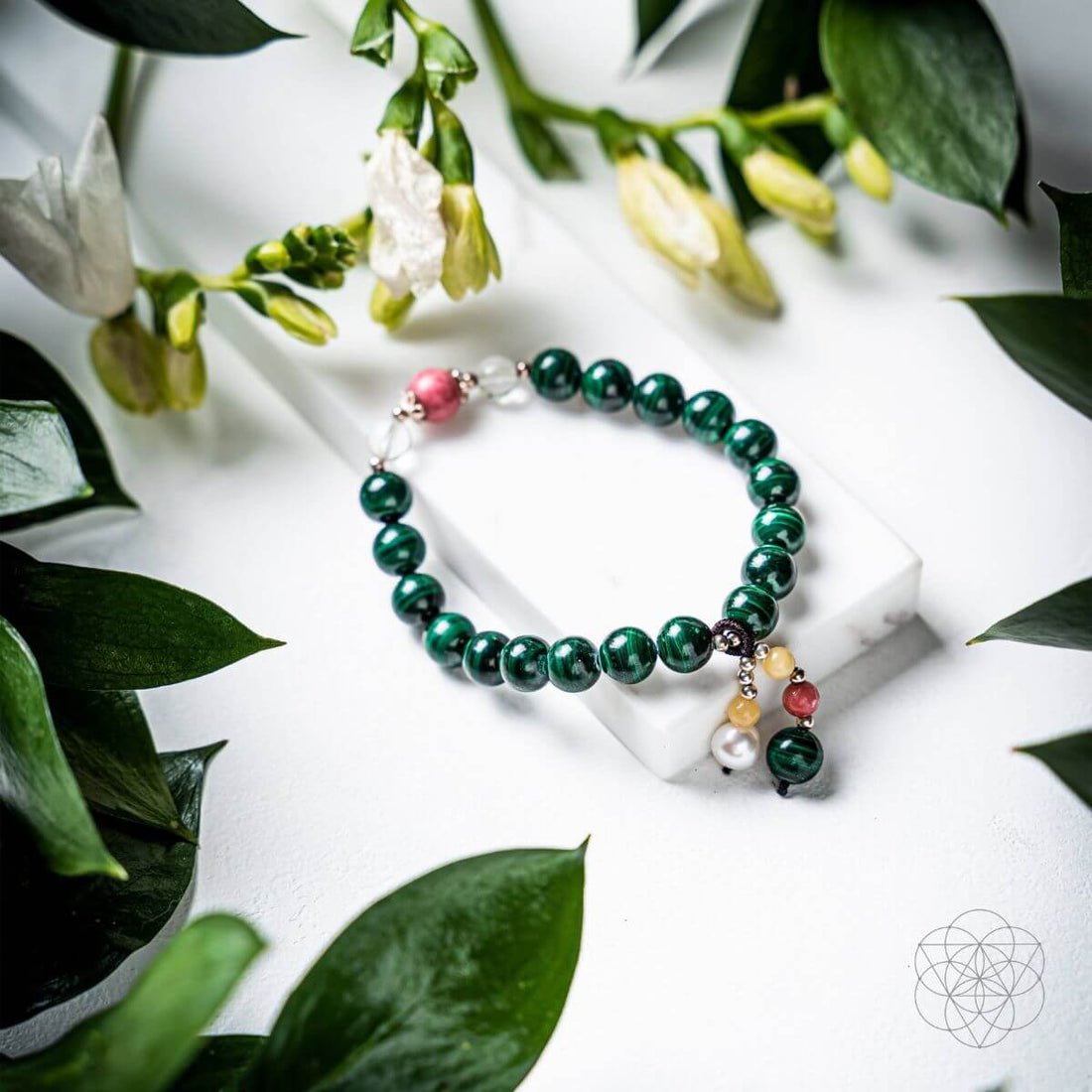 Close-up of The Law of Attraction Bracelet by Conscious Items featuring symbolic charms on a leather band.