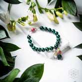 Close-up of The Law of Attraction Bracelet by Conscious Items featuring symbolic charms on a leather band.