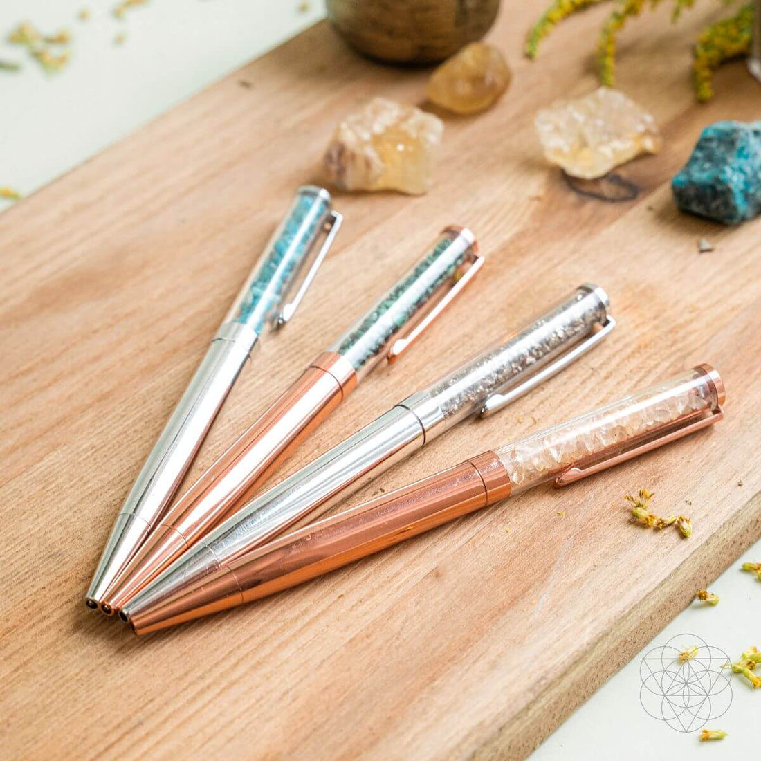 Set of manifestation pens from Conscious Items for abundance and positive energy, featuring inspirational designs and vibrant colors.