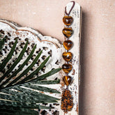 Decorative tassel from Conscious Items, The Protection Tassel, used as a stylish home decoration accessory.