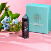 Rare Arfvedsonite point home decor piece by Conscious Items, showcasing a polished gemstone with vibrant blue and black hues.