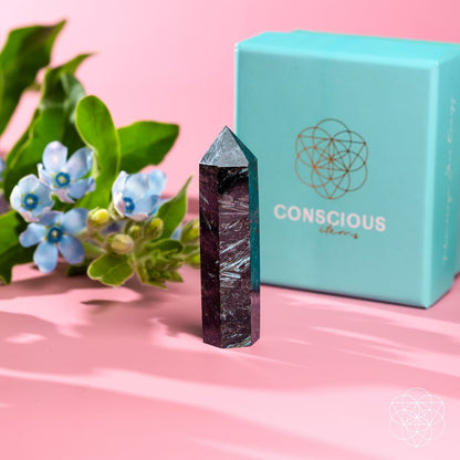 Rare Arfvedsonite point home decor piece by Conscious Items, showcasing a polished gemstone with vibrant blue and black hues.