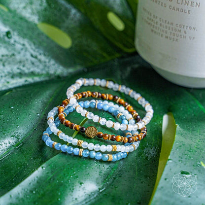 Set of four Conscious Items jewelry bracelets featuring the Endless Abundance design, made with beads and charms in mixed colors.