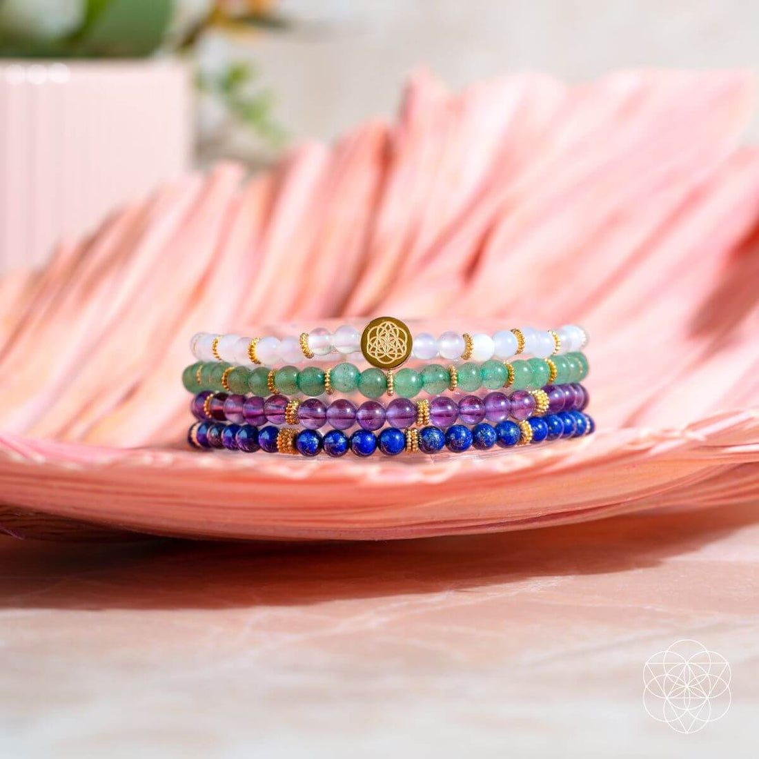 Set of four Conscious Items Good Karma jewelry bracelets featuring symbols of luck and success, crafted with natural materials.