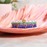Set of four Conscious Items Good Karma jewelry bracelets featuring symbols of luck and success, crafted with natural materials.