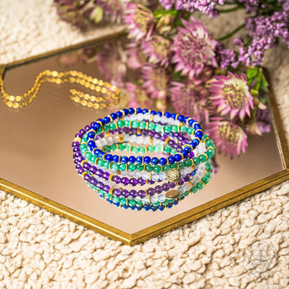 Set of four jewelry bracelets from Conscious Items Good Karma collection, featuring symbols of luck and success.