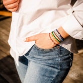 Set of chakra-balancing jewelry bracelets by Conscious Items featuring colorful beads and charms for spiritual wellness.