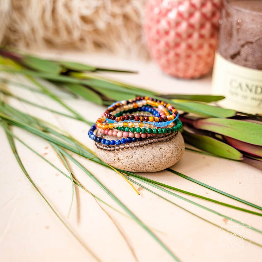 Set of chakra-balancing jewelry bracelets from Conscious Items featuring colorful beads representing each chakra.