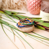 Set of chakra-balancing jewelry bracelets from Conscious Items featuring colorful beads representing each chakra.