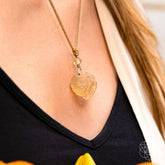 Libyan Desert Glass pendant necklace by Conscious Items, featuring a polished, translucent desert relic on a delicate chain.