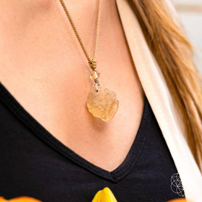 Libyan Desert Glass pendant necklace by Conscious Items, featuring a polished, translucent desert relic on a delicate chain.