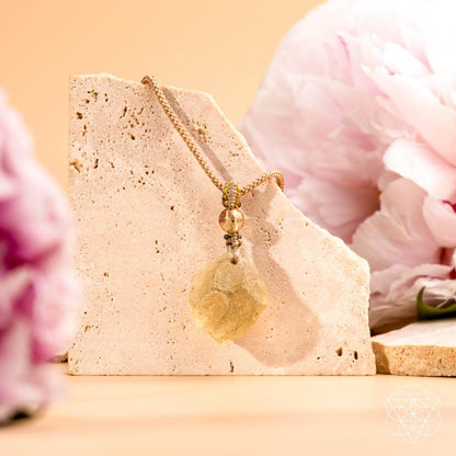 Libyan Desert Glass pendant necklace from Conscious Items featuring a striking, polished relic with natural amber hues.