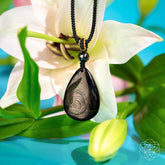Hypersthene Millionaire Manifestation Pendant necklace by Conscious Items featuring a polished stone pendant on a silver chain.