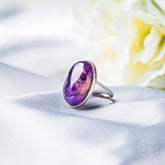 Close-up of The Visualization Ring by Conscious Items, a sleek silver ring with engraved motivational symbols on a white background.