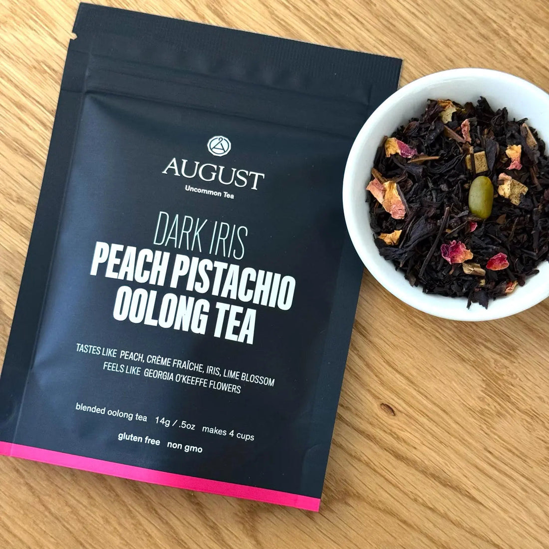 Four cups of Dark Iris Peach Pistachio Oolong Tea by August Uncommon Tea, showcasing the rich color and inviting presentation.