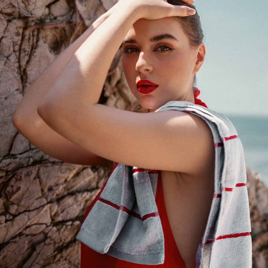 Deia Australian cotton hand towel from Italic, soft and plush, featuring a vibrant tomato red color and textured woven design.