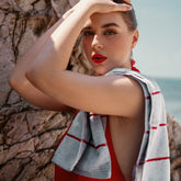 Deia Australian cotton hand towel from Italic, soft and plush, featuring a vibrant tomato red color and textured woven design.