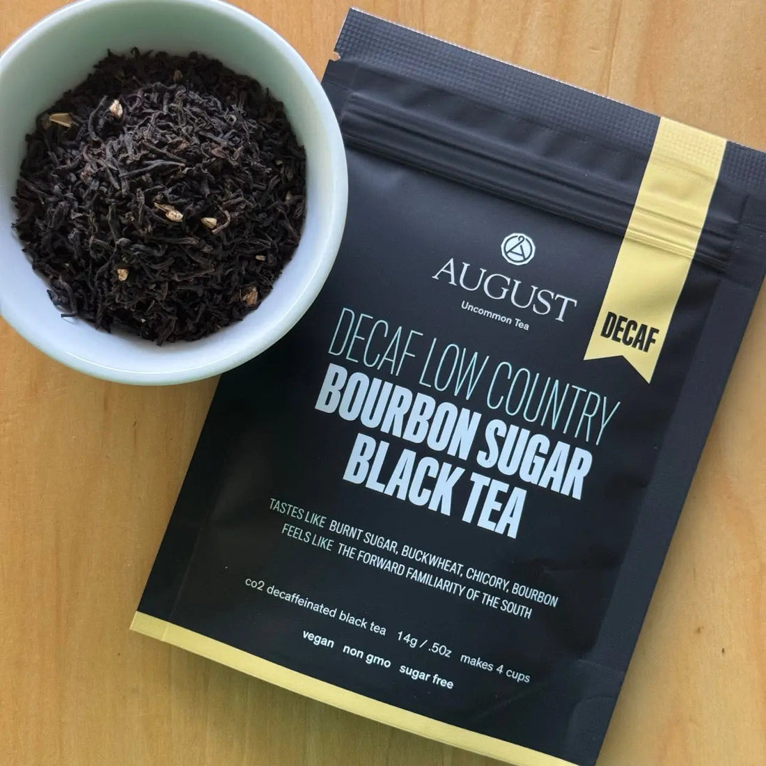 Four cups of brewed Decaf Low Country Bourbon Sugar Black Tea by August Uncommon Tea, showcasing rich dark tea in clear glass cups.