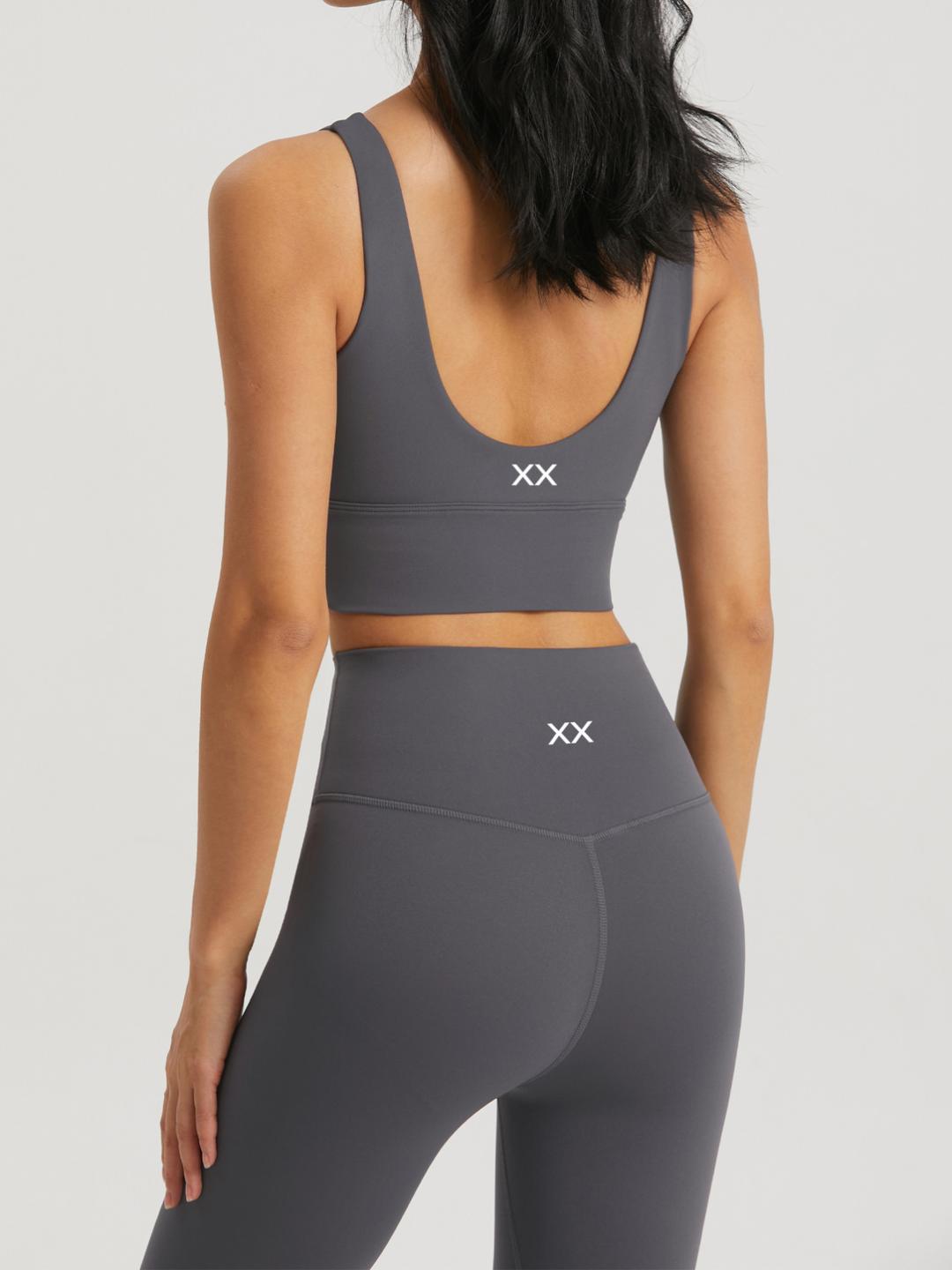 Blackout Barbell Omni Bra in navy, featuring supportive fabric and stylish design, shown on a model.