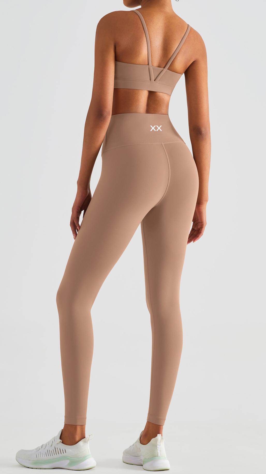 Light brown Echo Bra by BLACKOUT BARBELL, featuring adjustable straps and comfortable fit, shown on a model.