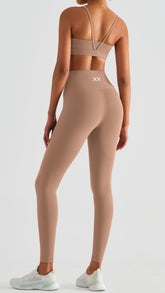 Light brown Echo Bra by BLACKOUT BARBELL, featuring adjustable straps and comfortable fit, shown on a model.