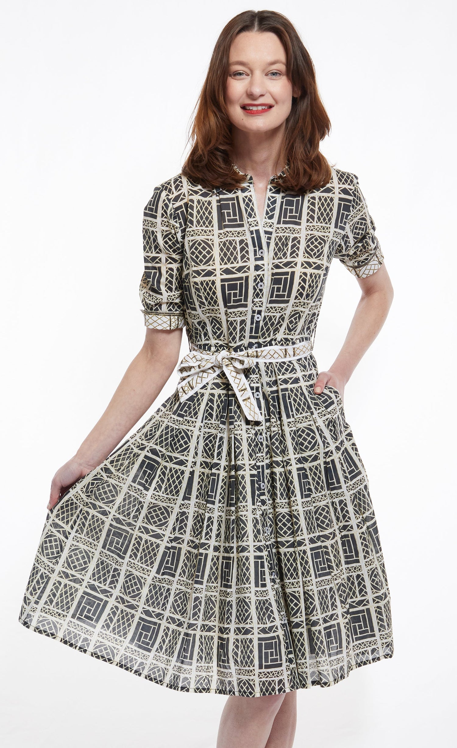 Dizzy-Lizzie Mrs Maisel black and beige wicker print dress displayed on a hanger, showcasing its stylish design and pattern.