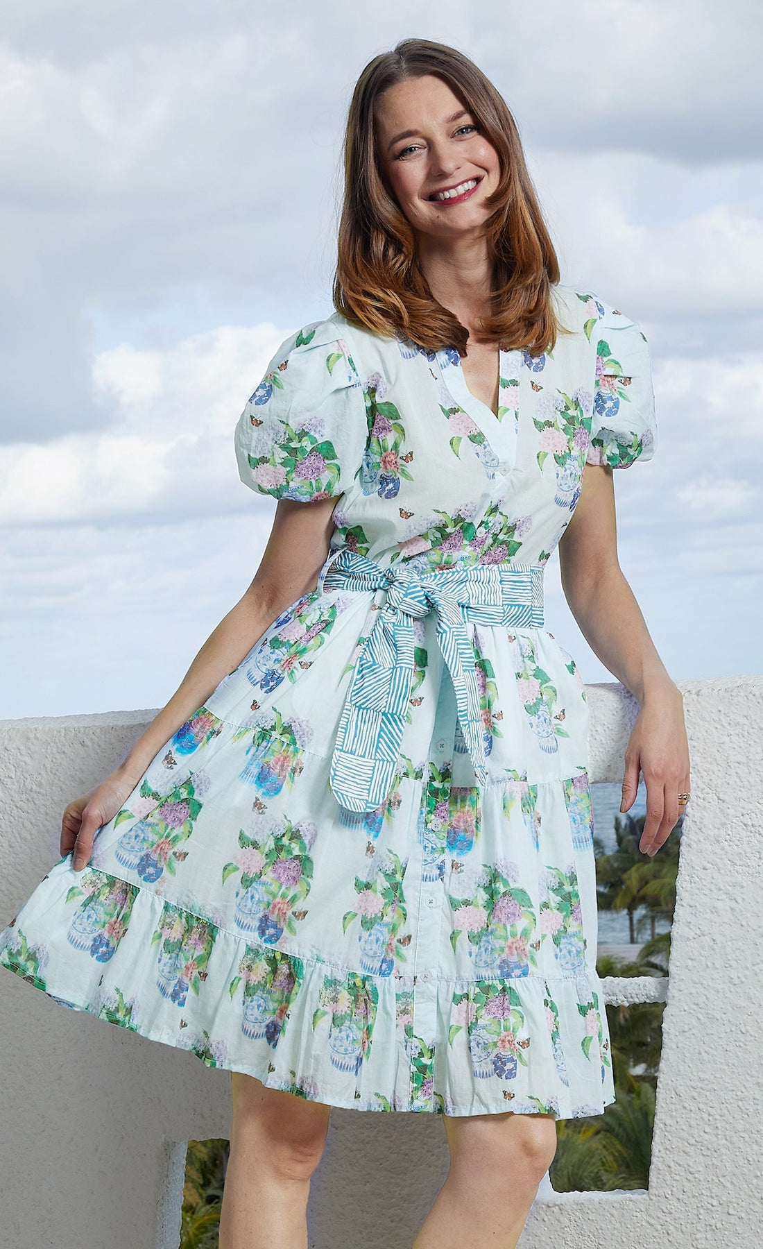 Dizzy-Lizzie Litchfield Short Blue Hydrangeas dress hanging on a rack, showcasing its floral print and short length.