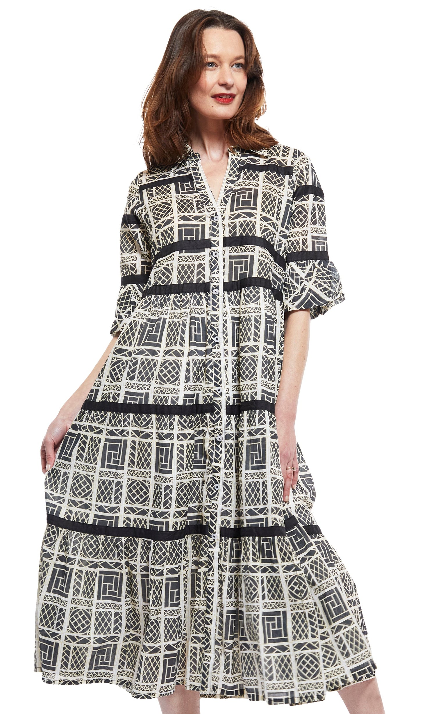 Dizzy-Lizzie Miami Style midi dress with black ribbons, white wicker details, flounce design, and black and white color scheme.