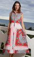 Dizzy-Lizzie Sea Island Dress with vibrant coral print, lightweight fabric, and flowing design perfect for warm-weather wear.