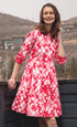 Pink watercolor print dress by Dizzy-Lizzie featuring a flowing design and vibrant floral patterns, perfect for casual or summer wear.