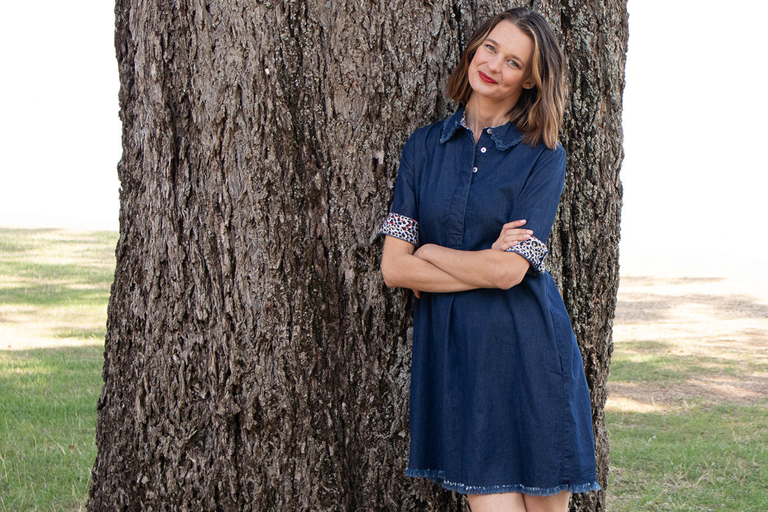 Light blue denim Hyannis Dress by Dizzy-Lizzie, sleeveless with fitted waist and casual style, displayed on a hanger.