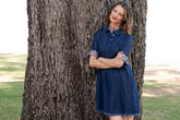 Light blue denim Hyannis Dress by Dizzy-Lizzie, sleeveless with fitted waist and casual style, displayed on a hanger.