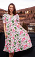White floral Montauk Dress by Dizzy-Lizzie, featuring a flowing fabric and elegant design, perfect for summer occasions.