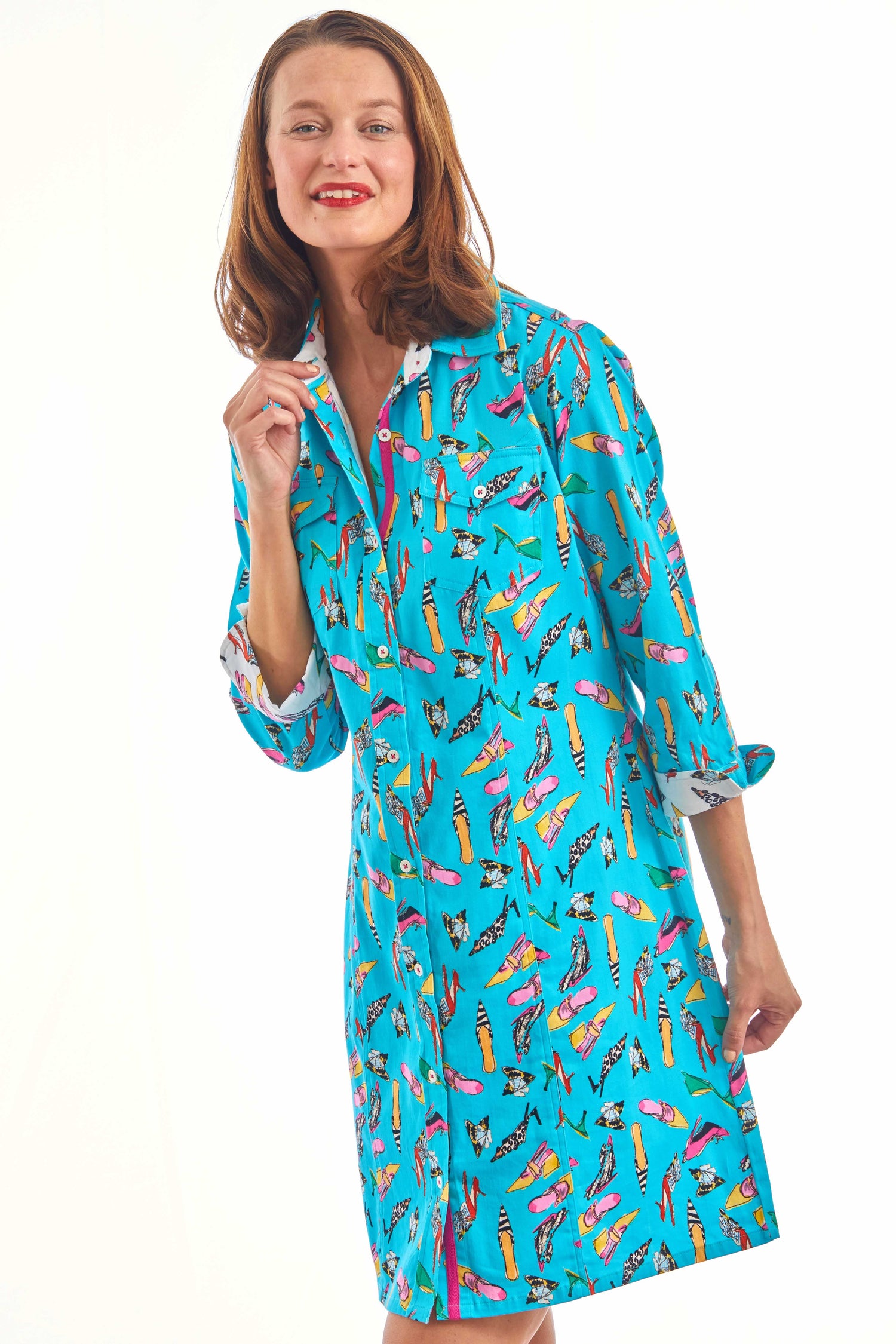 Turquoise Sag Harbor Dress by Dizzy-Lizzie featuring a shoe print pattern, displayed on a hanger against a neutral background.