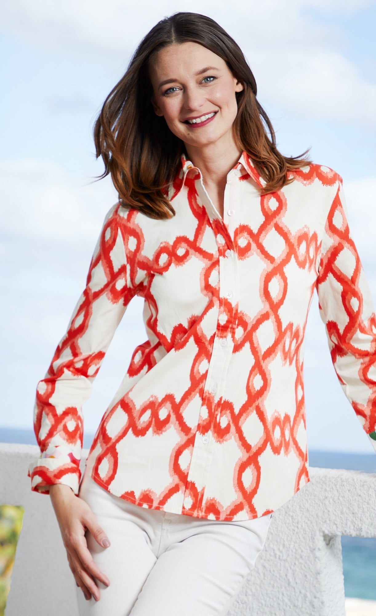 Orange and white flame stitch Dizzy-Lizzie Rome shirt displayed flat, showcasing its vibrant pattern and stylish design.