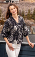 Black and white oversized puff sleeve shirt by Dizzy-Lizzie, featuring bold fabric design and relaxed fit.