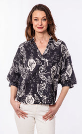 Dizzy-Lizzie oversized black and white puff sleeve shirt displayed on a model, featuring a relaxed fit and stylish design.