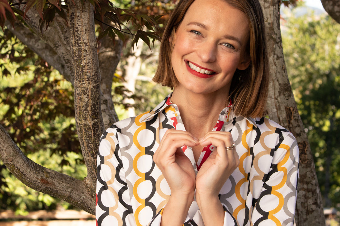Dizzy-Lizzie Rome shirt in fall colors with Olympic ring print, featuring a stylish casual design and vibrant color scheme.