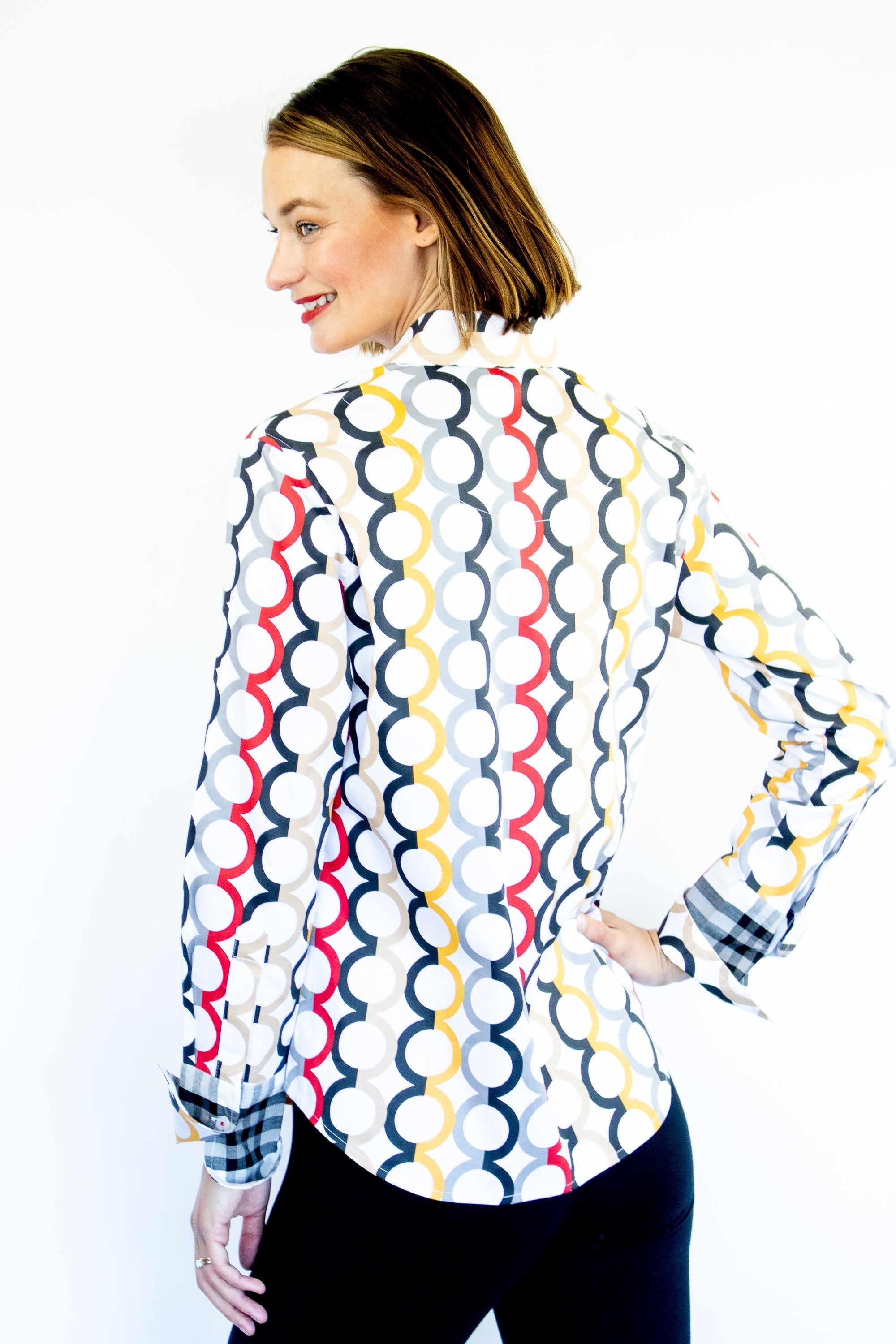 Dizzy-Lizzie Rome shirt in fall colors with Olympic ring print, featuring vibrant design and casual fit on model.