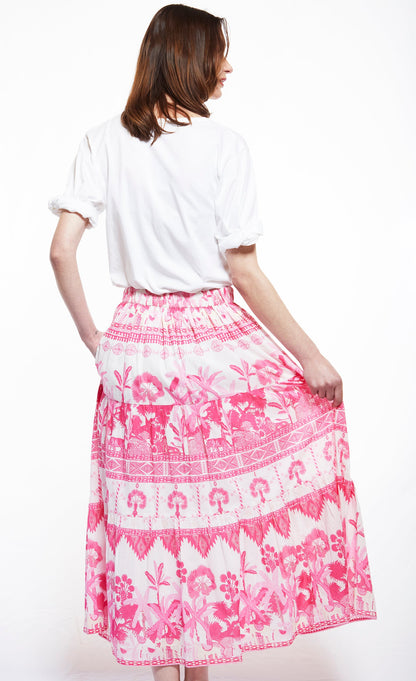 Dizzy-Lizzie Woodstock skirt with pink ikat print, flowing fabric and waist tie, perfect for casual and boho-inspired outfits.