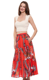 Orange abstract skirt by Dizzy-Lizzie featuring a flowing design and vibrant pattern, shown on a model.