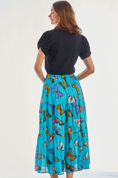 Woodstock turquoise butterfly pull-on flounce skirt by Dizzy-Lizzie, featuring a vibrant butterfly pattern and flowing lightweight fabric.