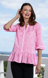 Pink and white peplum top by Dizzy-Lizzie, featuring a fitted style with ruffled hem and sleeveless design.