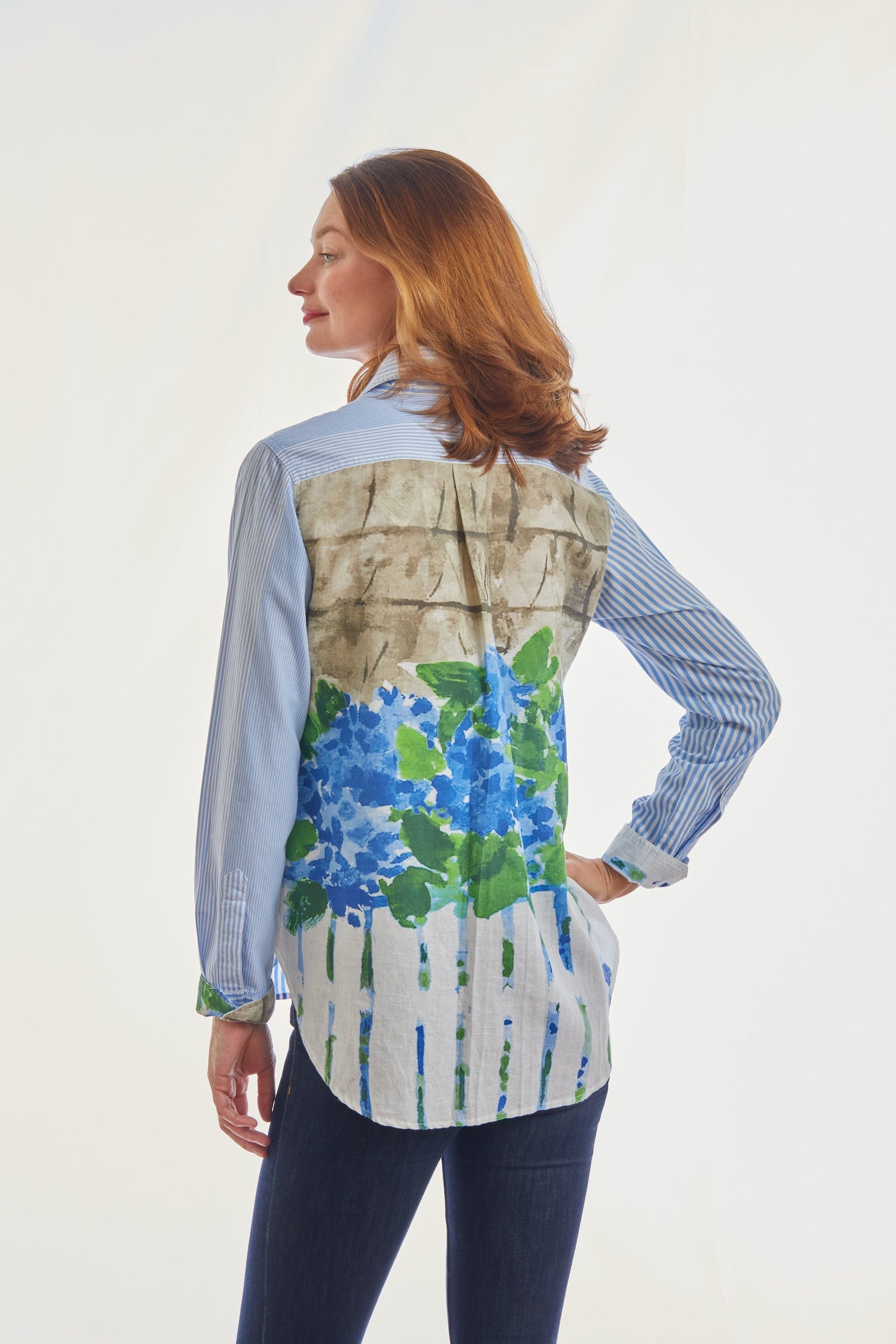 Dizzy-Lizzie Chesapeake top in blue and white stripe with back motif featuring picket fence and hydrangeas.