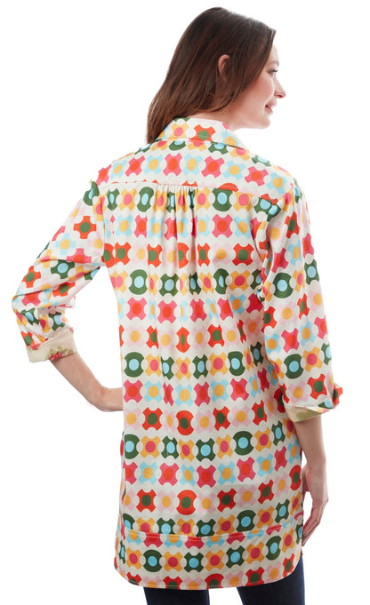 Colorful geometric patterned Vail Tunic by Dizzy-Lizzie featuring vibrant shapes and comfortable fit, displayed on a hanger.