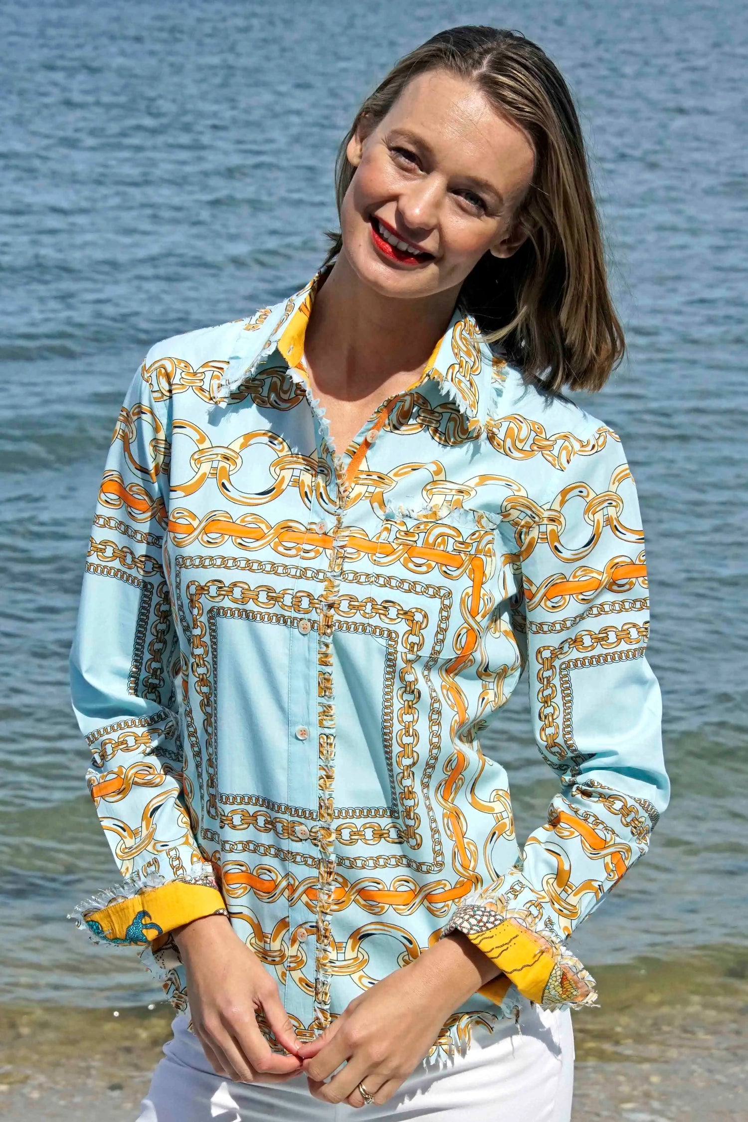 Dizzy-Lizzie Cape Cod Tunic in aqua ground with orange links, featuring a lightweight, flowy design and vibrant pattern.